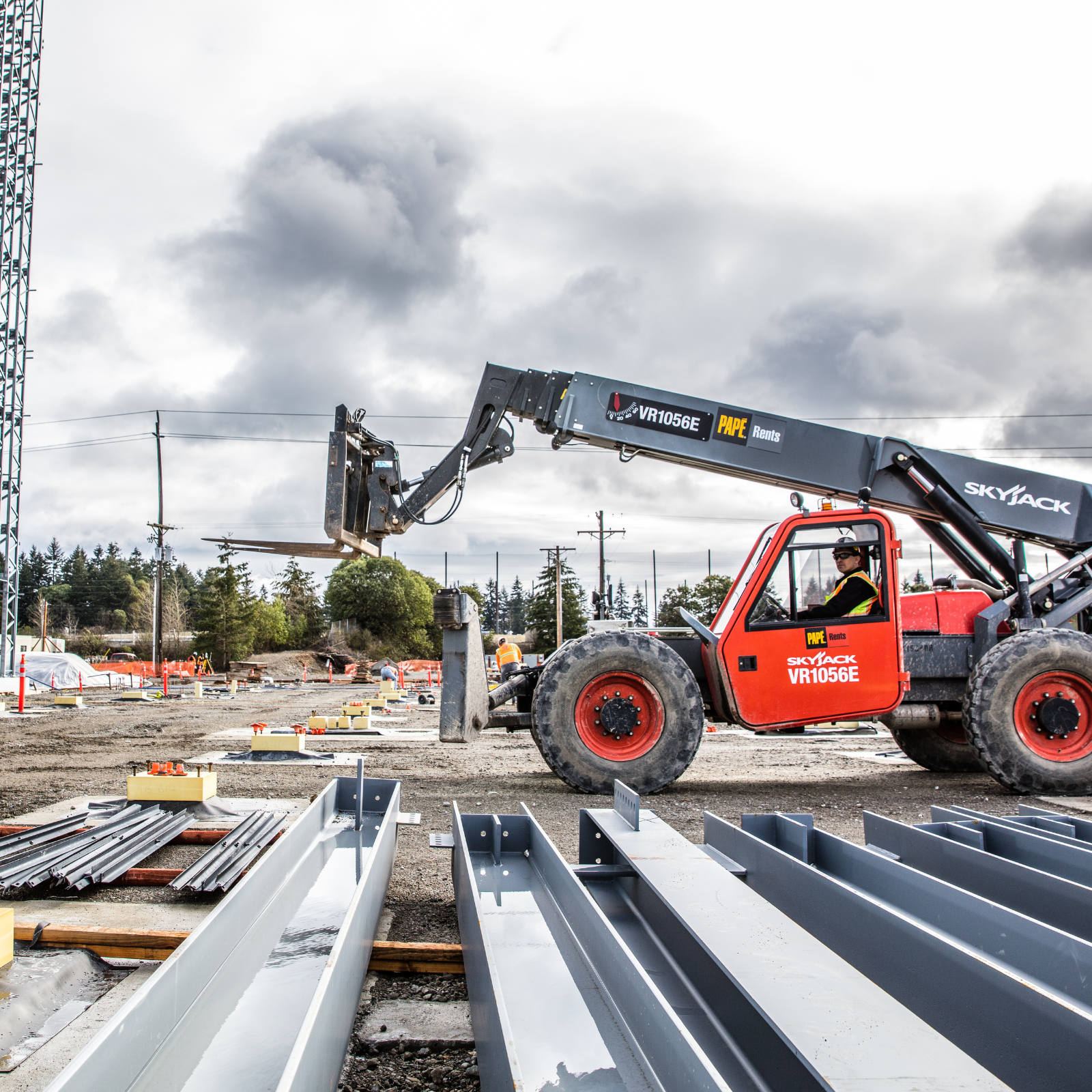 Telehandler lifting an unusual load using a specialty attachment on a construction jobsite