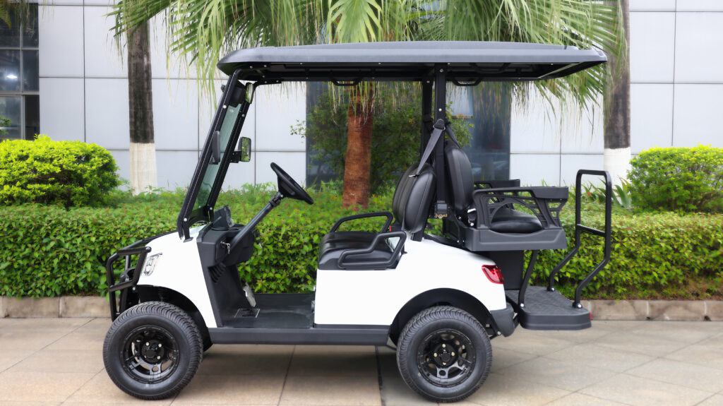 Side view of the Fusion 2+2 electric passenger cart transporting four passengers in a tight industrial campus environment