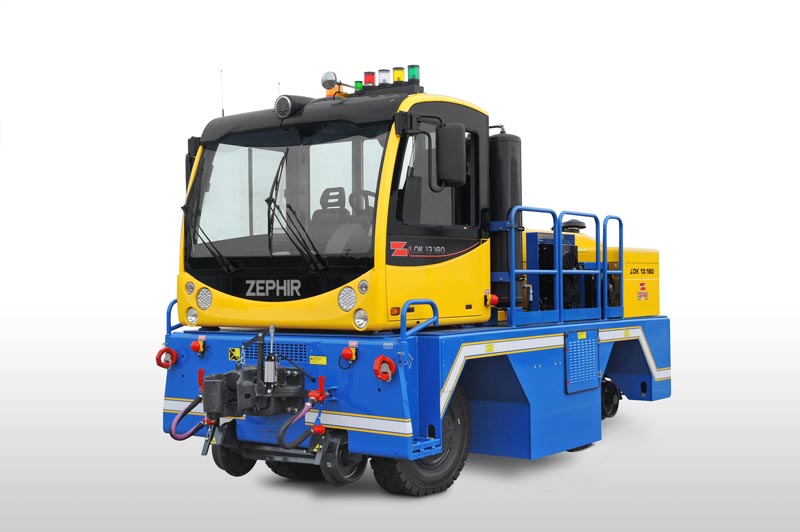 Zephir electric railcar mover operating on industrial rail spur, providing zero-emissions railcar switching for manufacturing facilities